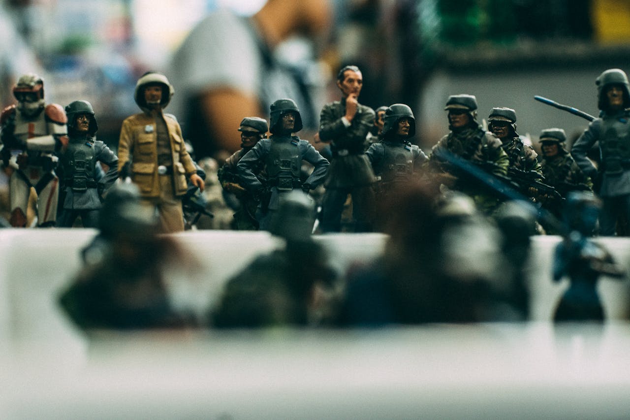 Detailed close-up of miniature toy soldiers arranged in a battle formation, showcasing military uniforms and weapons.
