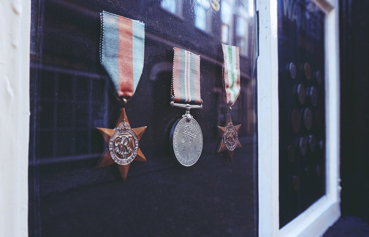 Close-up of historical medals displayed in a glass cabinet. Perfect for history and military themes.